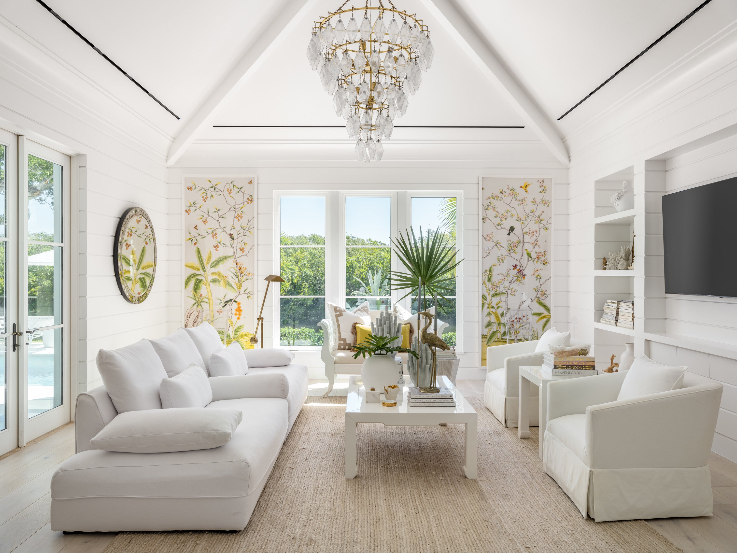 "Johns Island" Interior Design - Modern living room with white furniture, a chandelier, and large windows.