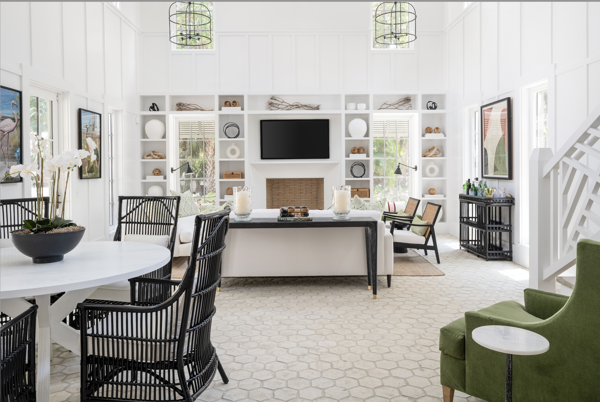 Modern living room with white walls, black chairs, and a green armchair.
